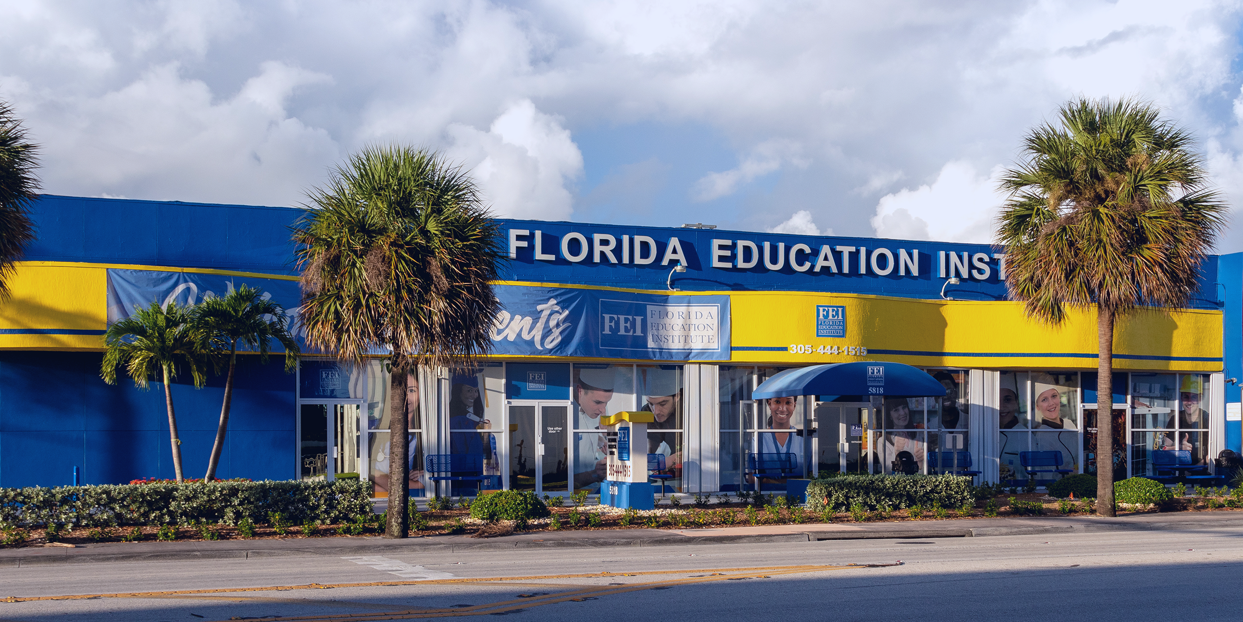 FEI's blue and yellow campus with palm trees in front